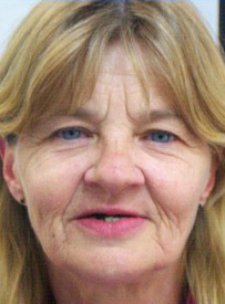 Middle-aged woman with blonde hair smiling at camera for dental care professional headshot.