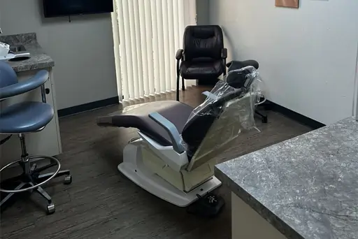 Dental examination chair in modern operatory with equipment and counter at Sunridge Dental Care