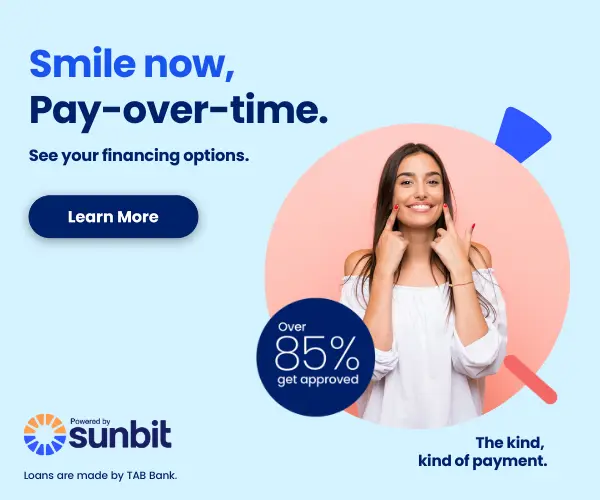 Woman smiling while holding phone, Sunbit financing promotion offering 85% APR dental payment option.
