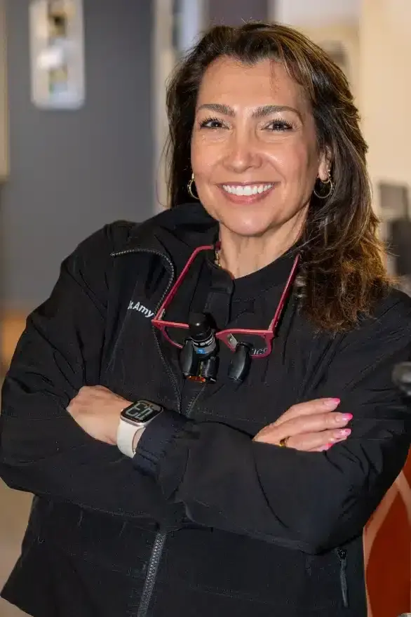 Dr. Amy Okun, dentist at Sun City West dental practice, smiling in professional attire.